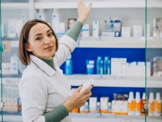 Pharmacist showing acne treatment creams available in Indian pharmacy